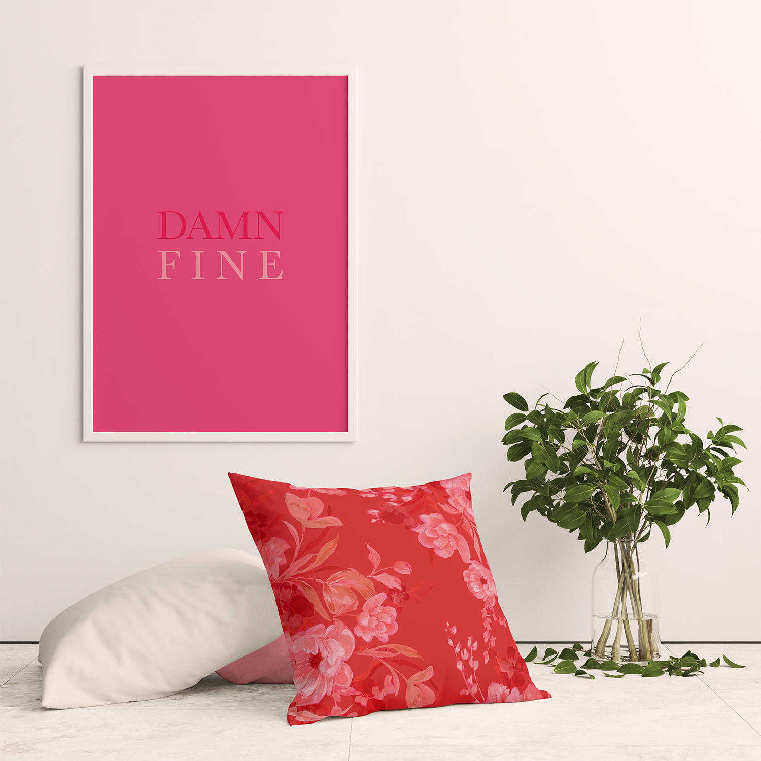 White interior scene with a plant and a bold, hyper-feminine decor featuring a ‘Damn Fine’ poster. Decorated with cushion covers in red floral, plain white, and pink patterns, highlighting the ‘unexpected red’ trend. Adds joyful decor and vibrant color, showcasing unique hand-painted designs by an independent artist, perfect for using color in space and decorating with print.